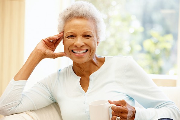 Senior woman with dental implants smiling.